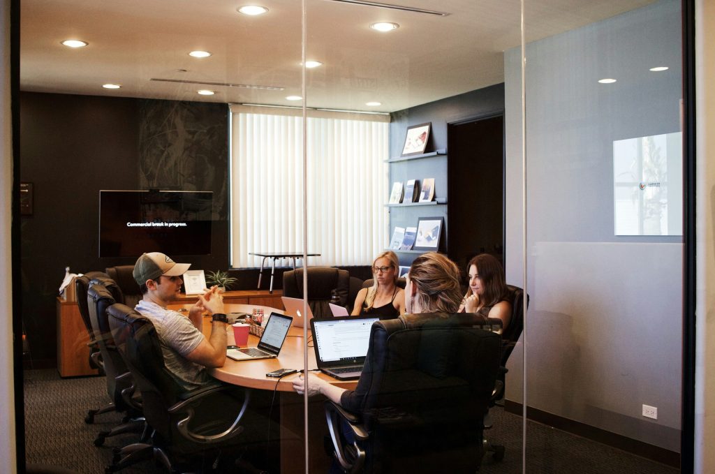 company employees sitting in board room