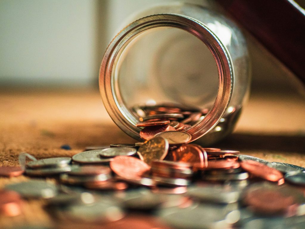 coins tumbling out of piggy bank